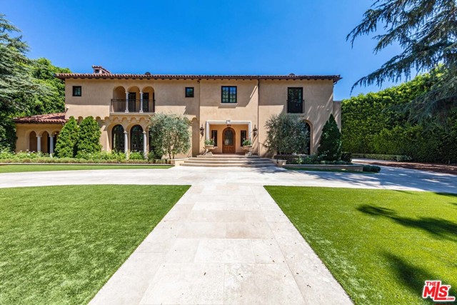 1010 N Roxbury Drive Beverly Hills, California Built in 1926 by Camduff and Camduff and reimagined in 2016 by architect Richard Manion, "Casa California," a 3-level Italian villa, combines Mediterranean Revival style with Spanish and Italian elements. Commanding over 210 ft. of frontage on Beverly Hills' coveted Roxbury Drive, a gated and hedged entrance framed by arching trees conceals private formal gardens. Rear grounds hold a pool, spa, guesthouse, and fitness studio. Inside, inlaid walnut hardwood guides visitors. A 2-story entry adjoins a living room with fireplace and doors to the front grounds. The library leads to the rear grounds, and a dignified dining room completes the formal areas. Adjacent to the chefs kitchen, a breakfast room and wood-paneled family room open onto the pool. Upstairs is a master suite with custom closets, sitting room, and terrace, and five guest suites. An elevator, entertainment room, bar, and wine cellar complete this timeless, 7-bed, 13-bath compound in the heart of Beverly Hills.