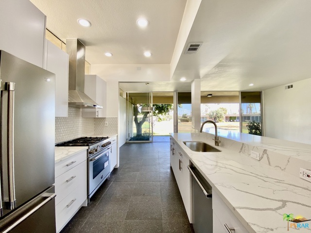 183 Westlake Drive Palm Springs, California UPDATED MID-CENTURY GEM! Richard Harrison designed 2BR/2BA home with lake view on 16th fairway has been professionally remodeled for today's aesthetics. Enclosed courtyard den removed and returned back to a large, private, sunny courtyard patio w/western St. Jacinto mountain views. (Unit now approx. 1,545 SF--Buyer to verify.) Tall ceilings, open kitchen w/stainless steel appliances; Bertazzoni 5-burner gas range w/hood & white Cambria quartz countertops. Bathroom skylights, white 3-D porcelain tile shower stalls w/new glass shower doors, undermounted sinks, Grohe single-lever faucets, Kohler WC. Terrazzo-like tile flooring throughout extends to terrace lanai. LED recessed lights, clerestory windows, lever door handles. Single carport nearby with parking directly in front. 7 Lakes Country Club is a 24/7 guard gated golf community: executive 18-hole golf course (par 58), 15 pools/15 spas, William Cody clubhouse w/dining, golf/pro shop, electric car charging stations.