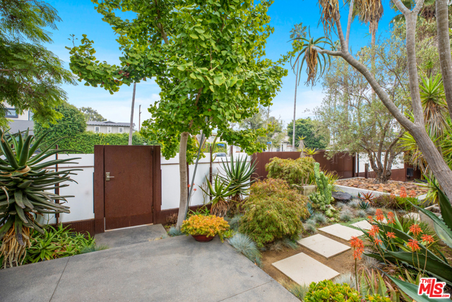 819 Milwood Avenue Venice, California Designed as a retreat from the urban environment, this discreet home and studio, on a large double lot, is the archetype legacy Venice property. Surrounded by botanical garden-quality landscape, with specimen plants from South Africa and Madagascar, the main residence evokes zen-like tranquility. Natural daylight softly bathes the interiors, with framed views to the outdoors. Meticulous attention was paid to every detail of the home. The working studio, designed by award-winning architect Steven Ehrlich, has soaring 30-foot-ceilings and is currently used as a painting atelier and a production office. Past uses include photography, sculpture and a music & dance space. Its perfect as a large-scale, work-from-home solution or a significant car collection. The flexible layout includes a two-office loft and a full studio apartment known as "The Treehouse," with a kitchen and laundry room. A generous outdoor roof deck has views to the ocean. This rare kind of property cannot be reproduced.