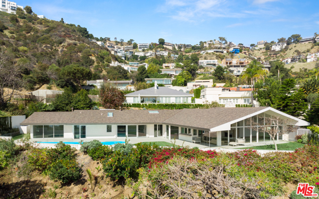 1667 RISING GLEN Road Los Angeles, California This iconic mid-century modern residence has been thoughtfully reimagined for the 21st century by internationally acclaimed architect Dan Brunn, AIA while maintaining its enduring mid-century appeal. Tucked behind gates off famed Sunset Plaza Drive, the home showcases bright, open living spaces with soaring ceilings, white oak floors, towering walls of glass and a distinctive, curved design. A soaring great room features a classic, double-sided stone fireplace and sliding glass doors to an outdoor dining area and bar with a pass-through window to the pool. Walls of glass line the open chef's kitchen, family room and master suite, fusing the spaces with an expansive, grassy yard and pool overlooking breathtaking jetliner views. An extraordinary example of mid-century design reinterpreted by one of Architectural Digest's Top 10 Rising Stars, this ultra-private celebrity enclave embodies the inimitable Hollywood Hills lifestyle with cinematic allure.
