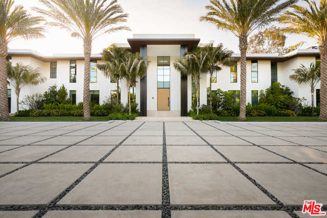 1525 San Vicente Boulevard Santa Monica, California Extensively remodeled in 2019, this extraordinary contemporary Santa Monica estate offers a custom living experience created and designed by world renowned ultra high end company Molori with 200-feet of prestigious Riviera Country Club frontage, magnificent fairway and mountain views, and exceptional amenities including a pool, spa, theater, karaoke room, and indoor basketball court. Mature palm trees line the entrance, surrounded by lush greenery. Offered fully furnished with custom-designed furniture, a stunning library with a fireplace, a formal dining room with seating for 25, an expansive wine cellar, and a gourmet chefs kitchen. The outdoor paradise includes approx. 125 ft+ pool, spa, magnificent pool cabana, and firepit area. The 2,500-SF primary suite offers a fireplace, dual marble bathrooms, dual walk-in closets, and a private balcony with golf course views. With the convenience of an elevator, an underground 8 car garage, and proximity to the beach, hiking, Pacific Palisades, Brentwood, and Montana Avenue, welcome to the epitome of world class design, astounding amenities, and supreme beauty.