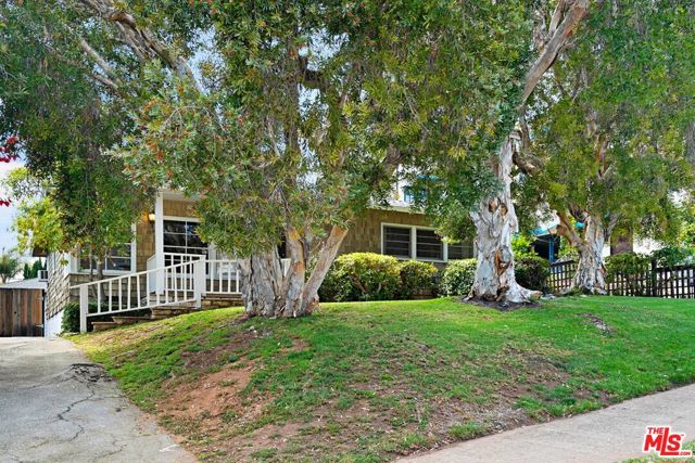 1047 Chautauqua Boulevard Pacific Palisades, California Pacific Palisades exceptional location. This prime location in Pacific Palisades offers an opportunity to build a home of your dreams on a 7070 sq. ft. lot. Make this your home, remodel, or build new. A location that offers the best of The Palisades life style just blocks from the heart of the shopping area, Palisades Village. Enjoy the Bay Theater, restaurants, and boutiques. Palisades Park, schools and library offer additional community amenities close by. The existing home is well situated above the street with a large back yard where there is a covered patio attached to the garage. The large master bedroom opens out to a 2 tier deck. There are hardwood floors and a stone fireplace in the living room plus 150 sq. ft. of outside storage and a detached 2 car garage. Tenant occupied to July 1, 2021. Do not come onto property unless accompanied by Listing Agent.