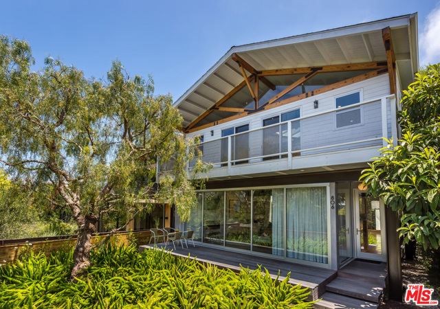 806 AMOROSO Place Venice, California Designed by Frank Gehry protegee, Brian A Murphy, this warm, inviting architectural home is perfectly located on "Love Street" - one of the coveted Venice Walk Streets. Centered around a 26' tall sun-drenched atrium at the heart of the house, sliding glass walls bridge the open and inviting interior to the expansive front deck and xeriscaped garden. Perfect for entertaining or a quiet night at home, the open floor plan includes a kitchen with custom cabinetry & Miele appliances & a flexible living space with gallery worthy walls. The backyard is beautifully landscaped & perfect for private relaxation or weekend barbecues. Upstairs you'll find all 3 bedrooms and integrated office. Primary suite features soaring tongue & groove ceilings, custom closets, & spa-worthy marble bathroom with walk-in shower. Other hi-end features include Mechoshades for complete privacy, LifeSource water purification system, Dornbracht fixtures, glass tread stairway & electric chargers in the 2-car garage, with 2 additional gated parking spots behind.