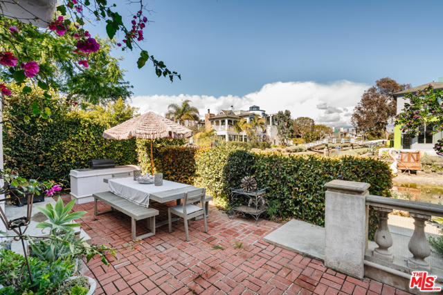 2333 Grand Canal Venice, California Experience the ultimate Venetian vibe on this rare double lot with whimsical water views. Romantically hidden behind hedges on one of the best T lot locations, this Morroco inspired Mediterranean offers an abundance of space to create your ultimate Venice beach hideaway. Wake up to the sunrise gleaming into your living room and walk along the shores as you step out of an expansive brick patio deck, capturing the variety of architecture and classic Venice style lined upon the Grand & Linnie canals. With a generous 4 bed 4 bath layout, enjoy open concept living and an ideal setting for creating, relaxing, and entertaining while the cool ocean breeze settles in. Perfectly located one block to the sand, a quick stroll to Erewhon & Abbot Kinney, and immediate access to all the best restaurants in town, this one of a kind double lot brings a European flair to the legendary life of the Venice Canals.