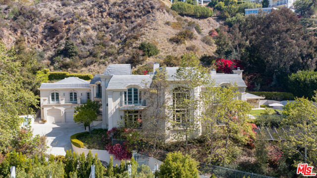 10509 Vestone Way Los Angeles, California This grand Contemporary Mediterranean estate is located up a private drive at the end of a secluded cul-de-sac. Enter through gates to an impressive motor court with parking for up to 15 cars and a 5 car garage. The home features large rooms and high ceilings, tall impressive iron and glass entry doors, a two-story entry, marble floors, an elevator, double powder rooms, and a second-floor family area. The 11,251 sq. ft. of interior features 7 bedrooms, 9 baths, a gourmet kitchen with a double island with granite counters, breakfast room with French doors. Spacious family room featuring hardwood floors, wet bar, fireplace, and French doors that lead to a grass lawn and pool with spa and cabana, secondary yard provides room for a sports court and/or children's play area. The formal library includes a loft. Spacious master bedroom with fireplace, separate his and her baths, large walk-in closets, large private balcony with views of the pool.