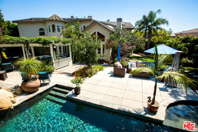 16855 Glynn Drive Pacific Palisades, California This custom built 5 bd home in Upper Marquez Knolls is a one of a kind private compound w/ resort like amenities. Dramatic 30 ft. entry, formal LR w/ vaulted ceilings & FP. Oak paneled library w/ FP. Formal DR. The gourmet cooks kitch has beautiful granite counter tops, center island, Viking range, Sub-Zero refrigerator, Miele dishwasher and lighted pantry. FR w/ open beam vaulted ceilings, wood floors, wet bar w/ wine refrigerator & dual beer tap. Mstr. Ste. w/ hardwood flrs, loft/study, step-up sitting room w/ FP. 3 addl bedrooms upstairs & 1 downstairs. Mstr. BA w/ high ceilings, skylight, lrg double shower, bathtub & 2 vanity sinks. Lrg Mstr cedar closet w/ built-in cabinets. Upstairs gym w/ corner tri-fold doors that open to a lrg balcony. Newer concrete tile roof, interior sprinklers throughout & solar panels. 800 plus bottle wine cellar w/ extra storage. The spacious 16,000 + corner lot w/regulation sand volleyball court, saline pool, spa, blt-in bbq, pizza oven & outdoor FP.