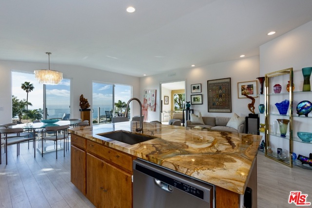 12 Aloha Drive Pacific Palisades, California Recently built, lux, custom, ocean view beach house. 1,000 steps to Will Rogers beach. Wide-open, superbly designed floor plan. Enjoy ocean views from the moment you walk through the front door. Wake-up to a private, ocean sunrise from the master bedroom suite with separate walk-in and slider, extra-large closets. The exquisitely appointed master bathroom has a separate high-mount soaking bathtub. The 2nd large master suite is located towards the front entrance. The 3rd bedroom is located on the opposite side of the entrance. The chef's kitchen has soft-close cabinets, a walk-in pantry, 5'7" ft. tall wine refrigerator, and a dedicated coffee cabinet. Huge, custom island with separate dining and living room areas. Solid core wood doors. Large deck with usable land below. Perfect for entertaining. Space for three-car parking. Custom side gates. The community has a heated pool and hot tub, gym, and rec room. Two dog parks.