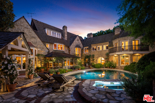 505 S Rimpau Boulevard Los Angeles, California Peerless details & a rich Hollywood history awaits in this English Country estate by architect, Gordon Kaufmann, located on a quiet tree-lined street in Hancock Park. Step into the stately formal entry which leads to the magnificent 3-story, wood paneled formal living room. Hand carved details embellish the fireplace, period moldings and doors. A den reminiscent of an English pub boasts a grand bar, hand hewn stonework & French doors that open to the gardens. Entertain in the gracious dining room, w/ direct access to the remodeled kitchen w/ Miele appliances. Upstairs, a dramatic library offers the ultimate place to relax or work, w/ a hidden door that opens to the master suite overlooking the gardens. Enjoy tranquil grounds w/ a lagoon style pool, jacuzzi, & paths that meander along streams & koi ponds. A storybook guest cottage & apartment & a multitude of seating areas complete the unique property. A serene oasis in the heart of LA, minutes from the finest leisure & entertainment.