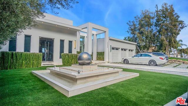 14455 Mulholland Drive Los Angeles, California Extraordinary Contemporary Estate in a gated cul-de-sac in Bel Air perched just off famed Mulholland Drive with spectacular panoramic city, canyon, and mountain views. Extensively remodeled, the architecture of this fabulous home delivers clean lines with walls of glass throughout that seamlessly fuse to integrate interior and exterior spaces and offer the ultimate Los Angeles lifestyle with great space for entertaining. Enter the estate through the double glass front doors to the spacious formal foyer. The walls of glass throughout the home showcase the incredible views and fill the rooms with natural light. The tremendous great room combines the living room and dining room with fireplace, full built-in bar, and refrigerated wine display. The main level also includes the gourmet kitchen with center island and professional appliances and family room with fireplace. There are 5 bedroom suites including the master suite complete with sitting room and luxurious bathroom. The outdoor space offers great space for entertaining with full outdoor kitchen and barbeque, multiple decks, spa, and infinity pool. Shows like a model home that's perfect for high profile celebrities and executives and families. Truly a one of a kind spectacular modern paradise!.
