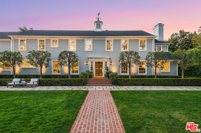 1101 Lexington Road Beverly Hills, California Prestigiously located North of Sunset, this exquisite traditional is sited on an expansive lot & nestled behind mature trees and manicured gardens designed by ArtLuna. The elegant foyer leads to the formal living room; anchored by a signature fireplace, refined millwork and a charming wet bar. The dining room & adjacent state of the art kitchen w/ oversized island provides the best in form and function. Gravitate into the open great room w/an oversized fireplace, dramatic 11 ft. coffered ceilings & french doors leading to the serene grounds. The main level is completed with 2 powder rooms and addl. bedroom/office option. Ascend upstairs to the ensuite jr. primary bedroom, 2 graciously sized addl. bedrooms with shared bath, & the impressive vaulted ceiling primary suite w/ a wrap around patio overlooking the pool, gazebo, and lawns. The backyard, enchants with modern functionality offering a pool, cabana/lounge area, built-in Viking Grill, alongside a complete guest house/1 bedroom apartment with kitchen and designer bathroom above the 2 car garage and exercise studio. Two landscaped side yards and a finished multi-car motor court completes the lush exterior of this sophisticated masterpiece.