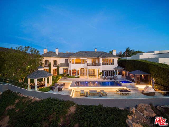 16224 Shadow Mountain Drive Pacific Palisades, California Fantastic value behind the 24-hour guard gated Ridgeview Country Estates on Shadow Mountain Drive. Positioned on the ocean view, ridge side of street, this family home awaits your personal touches. Fantastic location near the end of the cul-de-sac affords total privacy and security. A transitional villa style offering 6 ensuite bedrooms & 8.5 bathrooms with spacious public rooms for great entertaining and flow. 2 family rooms, first and second floor laundry, dual offices, 5 car garage and custom built 4000 bottle wine cellar are just some of the details you will find inside this home. An entertainer's backyard w/pool, spa, outdoor cabana/tv, outdoor living room w/fireplace/tv, gazebo, outdoor kitchen, fire pit, and putting green. VIEWS of the Ocean , the upper Bienveneda Vineyard and the setting sun are all part of the package. This well maintained home is close to the amenities in the Village yet a world away in feeling.