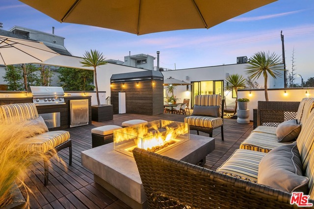 214 S Venice Boulevard Venice, California Two Blocks and its Toes in the Sand! Dramatic David Hertz redesigned Duplex or a live/work compound . This Strikingly beautiful Architectural home has an impressive roof top DECK ideal for entertaining, dining or star gazing. So close to the ocean & adjacent to the Venice Canals. A 3-bedroom 3 bath main home withan open kitchen fit w/ a walk-in pantry, wine cooler, Sub Zero fridge, Viking range, custom cabinets & intimate countertop dining for 6. Enjoy a 2-story reclaimed wood fpl lounge leading to a private atrium for AM coffee or PM cinemas. The Primary BR wing provides a prvt terrace which extends to the roof deck, fpl, custom walk-in closet & luxurious both w/ skylights. A separate one bedroom with a private entrance and sep garage guest house, office or rental with a full kitchen, laundry, & roof deck. Addl Gym/flex/garage up front & invaluable 3 car garage in back +1 spot. An expansive teakwood, deck overlooks the nearby canals & features a: BBQ grill, sink, fridge & firepit.