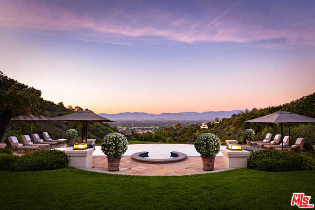 14035 AUBREY Road Beverly Hills, California Settled above the city lights, this elegant Tennis Court Estate features approximately 16,000 sq of luxury living all within the coveted 24 hour guard-gated community, Mulholland Estates. Featuring 7 bedrooms, 10 full bathrooms, a formal entry, dining room, expansive sous-chef style kitchen & over sized living/entertaining areas which are rich in character and full of volume. As you walk thru the home, you are greeted with floor to ceiling doors/windows that lead out to the resort-style backyard with an infinity edged pool, tennis court & outdoor dining areas which offer an unparalleled lifestyle of seclusion, luxurious comfort & lavish entertaining. Additional features include a library/office, elevator, gym, 10-car garage and an entertainment floor encompassing a home theater, game room & wine area. The classic yet sophisticated home awaits the next buyer to fully experience the Southern California lifestyle at its best.