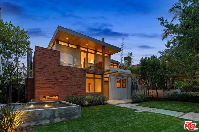 322 14th Street Santa Monica, California Masterfully built by Sarlan Builders, this six-bedroom retreat is a true feat in modern architecture in a highly coveted locale North of Montana. Via a stunning concrete exterior stacked with flagstone, the double-door entry opens to reveal a spacious, naturally lit floor plan that flows effortlessly into each main-level living space. Here, find a contemporary great room, a formal dining space, and an open-concept living room and a state-of-the-art chef's kitchen with a large center island and pantry, both embraced by floor-to-ceiling windows for a stunning living environment that blends seamlessly with its natural surroundings. Among the homes six en suite bedrooms is the luxe primary suite with vaulted ceilings, a spa bathroom with a soothing blue aesthetic, dual closets, and a tranquil balcony. Beyond the home's interior, discover a true outdoor oasis with a 65-foot lap pool and spa, covered patio space for dream-worthy entertaining and two-story guest home with its own entrance, ideal for an additional living environment, studio or unmatched work-from-home space. Showcasing a timeless blend of glass, wood and concrete, this modern yet inviting industrial-inspired home sets forth a truly stylish and sought-after living experience in Santa Monica.