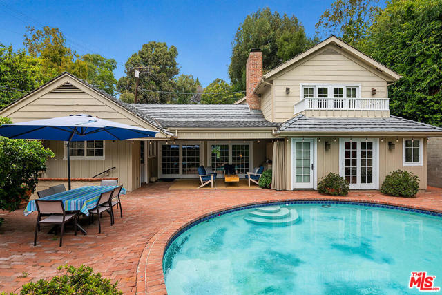 360 N Kenter Avenue Los Angeles, California A hidden gem with great value on a large lot with complete privacy is not to be missed. This Traditional home has two full beautifully landscaped backyards. One is a rose garden setting and a large lawn for activities. The second is a sparkling swimming pool surrounded by multiple fruits and citrus trees, a covered lanai with a flat-screen for enjoying movies and sports. Fantastic for entertaining or enjoying and working from home. The floor plan includes a living room with vaulted ceilings, builtin entertainment center with surround. The first level includes 2 bedrooms and office areas, a family room with hardwood flooring, and 2.5 baths. The upstairs master has walk-in closets, a terrace overlooking the pool, steam shower, and a spa tub. The upstairs has the potential for a second full office, gym or nursery. This home was renovated and rebuilt 11 years ago. A pool fence is onsite. Priced to move quickly.