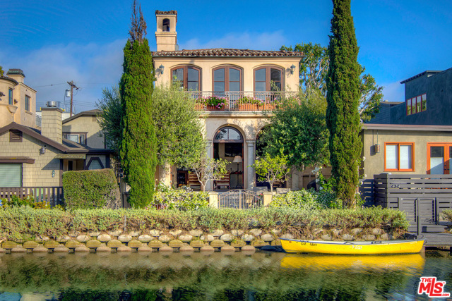 438 Howland Canal Venice, California Island location on the Venice Canals. Truly a once-in-a-generation property, this elegant 3-story Tuscan-style home is among the largest & most coveted homes in the Venice Canals enclave. Built & maintained with attention to detail, designed by architect Louis Tomaro, features spacious rooms, balconies, high ceilings & designer touches throughout. Gourmet eat-in kitchen w/butler's pantry and Viking & Sub-Zero professional appliances. Subterranean garage below creates impressive floor plan with soaring volume creating dramatic space and light. Oversized living room with 12-foot ceilings opening to large, waterfront yard w/mature olive & cypress trees. Spacious master bedroom suite w/sitting area, private balcony overlooking Howland canal, lavish bath with jetted spa tub & shower. Dramatic entry rotunda with flowing stairway & skylights; 3 large bedrooms (2nd bedroom is extra large, can be split to make a 4th bedroom), 3.5 baths. This timeless architectural masterpiece will bring your heart to the European countryside. Close to beach, Abbot Kinney and marina.