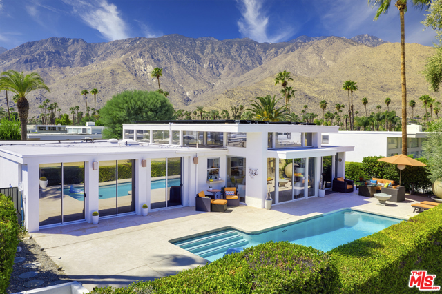 2696 E Kings Road Palm Springs, California Back on Market - Clean Inspections Reports available. Famed Architect William Krisel's design of this Mid-Century Modern gem includes his signature high ceilings with clerestory windows providing views in all directions. This Palm Springs paradise offers a private heated pool with a large back patio. Ideally laid out with 3 en-suite bedrooms, plus guest powder room and an open great room with multiple entertain areas including a coo mid-century bar with pass through window to pool and large dining area. This mid-century dream property is perfectly positioned on the Indian Canyons Golf Course with views of the Stunning San Jacinto Mtns, San Bernardino Mtns and the Historic Disney fountain. Upon entering your eyes will widen in delight as you enjoy stunning views and natural light from the many sliding doors & windows. The interiors have been thoughtful updated with a blend of contemporary & mid-century elements that offers comfortable and stylish living.