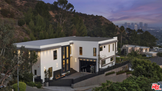 1754 Clear View Drive Beverly Hills, California This spectacular brand new construction sits on over an acre lot at the pinnacle of Clear View Drive with unobstructed city and ocean views! Inside its gates, this contemporary dream is an oasis of tranquil beauty, offering breathtaking views and stunning interiors. Floor to ceiling glass doors create the perfect environment with volume and light. The open floor plan delivers 12 ceilings, quintessential indoor/outdoor and ample bedroom count with resort quality amenities and views throughout. This spectacular home features imported French silk white oak flooring, Fleetwood pocket doors, control 4 home automation with security system, 7.1 Dolby Digital theater system, two beautiful fire features, a 2,000 sqft master suite and so much more. Refined interiors at every turn will wow the most discerning eye. Multiple water features and lush landscaping create an enhanced sense of zen. On a cul-de-sac on one of the best streets in Beverly Hills Post Office, easy access to some of LA's best hiking trails and a couple minutes from the city. This magnificent property offers a lifestyle of elegance & privacy at it's absolute finest!