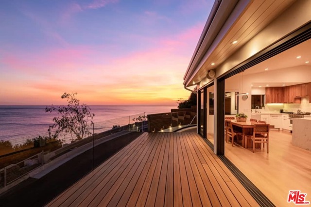 17856 Porto Marina Way Pacific Palisades, California Pacific Palisades By Sea ,unobstructed white water ocean view to Catalina Island, Palos Verdes, and Queens necklace. Stunning updated contemporary! home approximately 2030 square feet and 800 outdoor deck with fire pit and glass wall. Two bedrooms including master suite on main level ,open floor plan with office area, living room with fireplace. Dining room and breakfast bar, gourmet kitchen includes Bertazoni oven and range, Bosch refrigerator, built-in Sharp microwave. Separate entrance to studio guest apartment/screening entertainment room with 3/4 bath and kitchenette. Teak wood floors ,Fleetwood doors open to the deck with amazing unobstructed white water ocean views watch sail boats and dolphins swim by along the surf. Attached garage with Tesla charger.