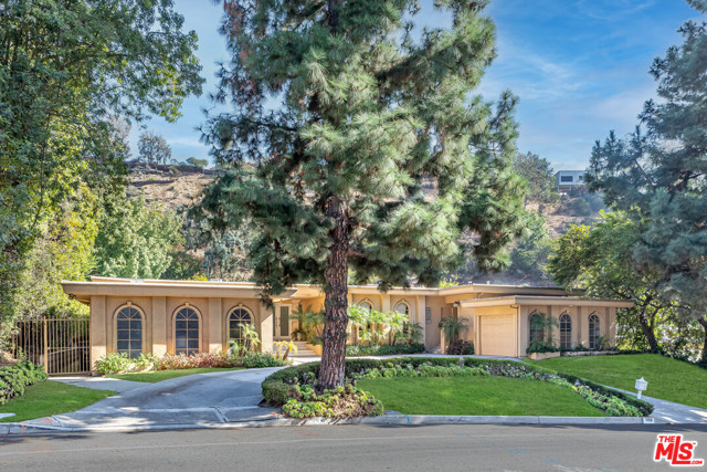 1856 Loma Vista Drive Beverly Hills, California $1,000,000 Price Reduction! Glamorous traditional home, located on one of the most illustrious streets in Trousdale Estates. This 5bd 5ba home is 5,000 sqft on a 26,556 sqft lot. Chefs kitchen that catches your eye with attractive appliances including a Sub Zero ref, Miele Double Ovens, 6 Burner Viking Range, Custom lighting, custom cabinets, pantry & butler's pantry w/ storage. Breakfast area viewing its lush grounds & dazzling pool, large family room w/ custom FP, & crown molding throughout. Step down bar that overlooks a private yard, French doors, living room w/ custom designed FP mantle, powder room w/ travertine & limestone counters, designer tile, separate maids rm, 3 additional large bedrooms all w/ hardwood floors, updated baths, & private sauna. Glamorous Master suite, with two walk in closets, separate office, & a master bath w/ rain head, body sprayers, soaking tub, limestone counter, travertine floors, dual sinks & plenty more!