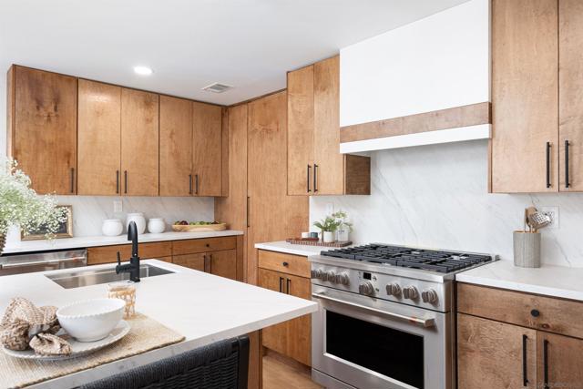 Custom hand built cabinets and porcelain backsplash along with upgraded appliances are the highlights of this kitchen