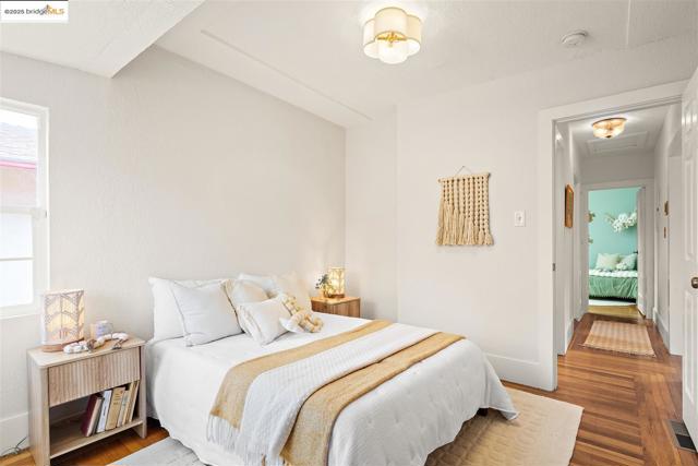 Bedroom with wood finished floors and attic access