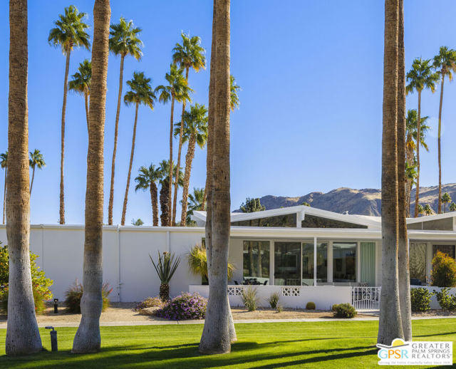 An expansive patio is at the back of the home, surrounded by drought-tolerant landscape.