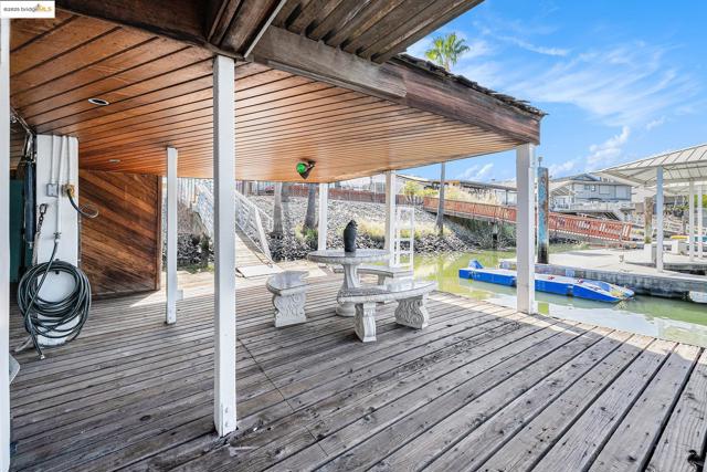 Wooden deck with a dock and a water view
