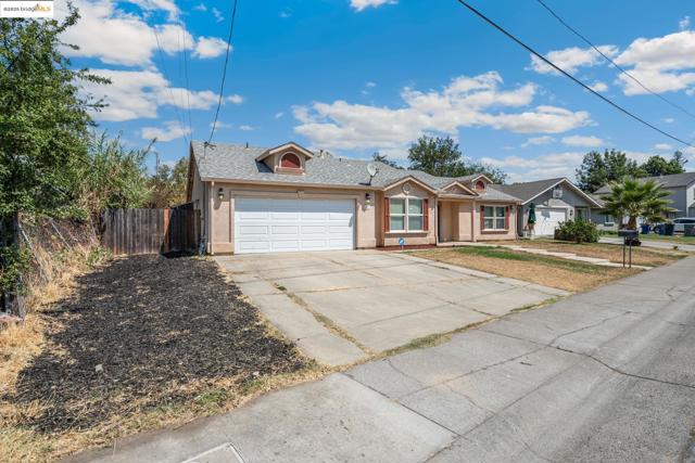 Single story home with an attached garage, driveway, and stucco siding