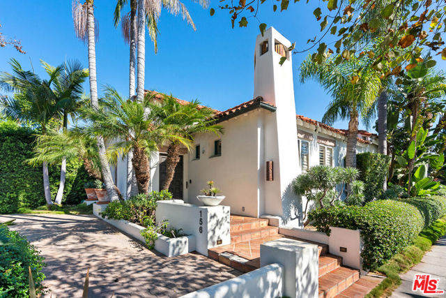 Embrace the timeless allure of classic Spanish architecture in this stunning Beverly Hills home. With 3 bedrooms and 3 baths, this single-story gem seamlessly blends old-world charm with modern luxury. As you enter through the heavy carved wood front door, the soaring, exposed beamed-wood ceilings and Spanish design accents will captivate you. Sunlight streams through clerestory windows, highlighting exquisite details like vaulted wood beam ceilings, hand-crafted ornamental metalworks, and artful fireplaces. Entertain with flair in the living room with an oversized fireplace and bright floors, complemented by a wet bar and custom built-ins. The updated kitchen boasts warm wood cabinets, quartz countertops, and a sunny breakfast nook with built-in shelves. The master suite offers outdoor views, a closet alcove, and a luxurious bath. Outside, a romantic private patio features an in-ground spa and a dining area with sparkling lights. Additional amenities include light fixtures, lush landscaping, an off-street driveway, and a basement. This home is nestled in the acclaimed Beverly Hills school district, close to the finest shopping destinations. Live in classic elegance with modern comfort in this Spanish-inspired oasis.
