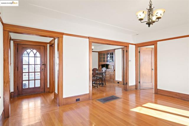 Foyer with hardwood / wood-style floors and a chandelier