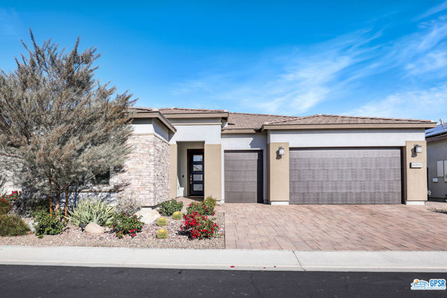 82650 Walker Canyon Drive Indio, California Welcome to the desert resort lifestyle in the 55+ community of The Trilogy Polo Club. Gorgeous upgraded home is a "Liberty" model open floor plan with 3 bedrooms with ceiling fans, 3 baths and 10 foot ceilings. The large primary suite offers fireplace, spacious custom walk-in closet and beautiful tiled bathroom. One of the guest bedrooms is also en-suite with walk-in closet. The 3rd bedroom presently used as an office with custom library cabinetry will accommodate a queen size bed. Within the entry hall is a wonderful additional office/den with sleek, modern bypass glass partition providing more light. Other upgrades include tiled floors, an exceptional kitchen with stainless appliances, pantry and a wonderful island overhang providing comfortable counter seating, custom built-in wall space for large living room and primary bedroom TVs and slim wall fireplaces. Motorized window shades are controlled by a remote or via phone App. There is recessed lighting, exceptional modern hanging light fixtures and LED motion night lighting. A 2-car garage plus cart garage has custom epoxy flooring, a full wall of storage cabinets and a long slatwall for hanging solutions. Both front and back yards with mountain views feature beautiful builder upgrade desert landscape, garden lights, stone pavers and extended covered back patio with recessed lighting. Trilogy at The Polo Club is a guard gated community with a private, hospitality-staffed Resort Club offering tennis, pickle-ball, resort floating pool and swimmers lap pool, gym and wellness center, billiards room, signature restaurant, social activities and much more. Trilogy's central location offers easy access to fashionable boutiques, retail stores, legendary golf courses and an assortment of quality dining options in Indio and in neighboring La Quinta, Palm Desert and all the Desert Cities.