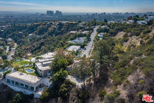 BUYER DIDN'T PERFORM IN TIME TO SATISFY THEIR 1031 EXCHANGE. Over 2 acres set at the end of a cul-de-sac and up a long driveway lies this incredible development opportunity. Views look out over Franklin Canyon Park and the rolling hillsides and around to city views from downtown to Palos Verdes. Remodel the existing structure or create an almost 21,000 square foot new construction home (per Underbuilt). Set amoung homes currently selling north of $20 million.