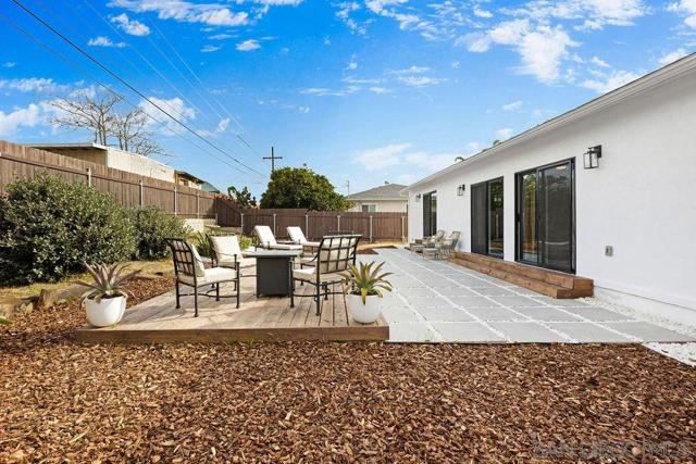 Concrete slab squares and custom built wooden deck really makes the backyard shine.