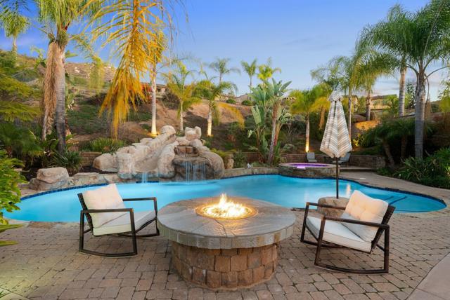 Pool with slide and waterfall, jacuzzi with more lounge areas, gas fire pit.