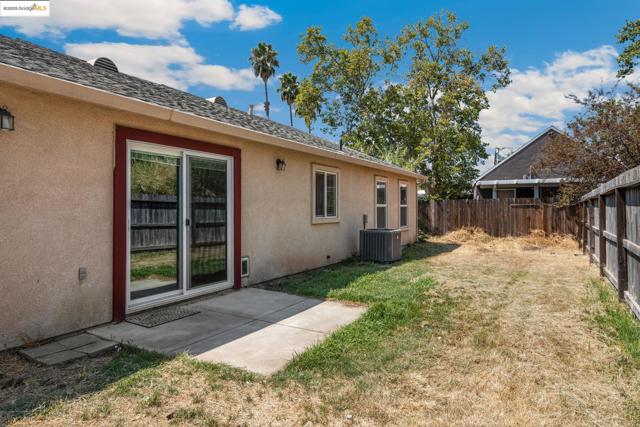 Fenced backyard with a patio