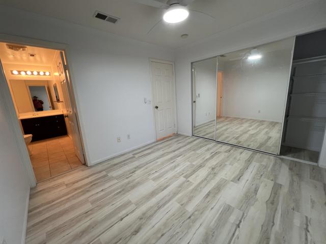 MASTER SUITE BEDROOM 1 WITH FULL BATH AND MIRRORED CLOSET.