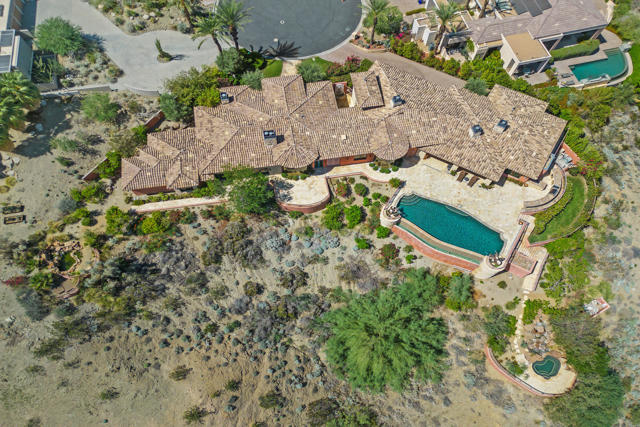 This incredible custom home offers Dramatic Down Valley & Mountain Views, and the Ultimate in Privacy on a 1-Acre custom lot.This home was designed and built with the finest finishes and amenities intended for ''Luxury Living''.  The 4 bed (2 Master Suites, 2-ensuites for guests), 8 baths, 6500+ sq ft is in the highly desirable 24-hr gated community of Mirada Estates.Passing through the large double glass entry doors, your eyes are instantly drawn to the custom floor to ceiling wall of glass and magnificent views from the elegant living room.  As you walk through this home, you can't help but to admire its quality... you have to to see it to soak it all in!  The coffered custom ceilings in each area of the home, the gorgeous travertine flooring throughout, french doors, custom wall finishes, the elegant lighting, 4-fireplaces, 2-separate office areas (Main Office/Library and in the main Master Suite), the incredible infinity pool, the entertaining outdoor fireplace and covered patio, the private spa/grotto, the stocked KOI pond, mature landscaping, flagstone walkways/patios, and the outdoor BBQ kitchen area.The Gourmet Kitchen boasts Wolf appliances, Sub-Zero refrigerator, a separate butlers pantry & coffee bar and a walk-in pantry.The Great Room with large fireplace creates a light environment for entertaining and stunning views that include an outdoor living space second to none.Homeowners enjoy discounted amenities at the 5-star Ritz-Carlton.