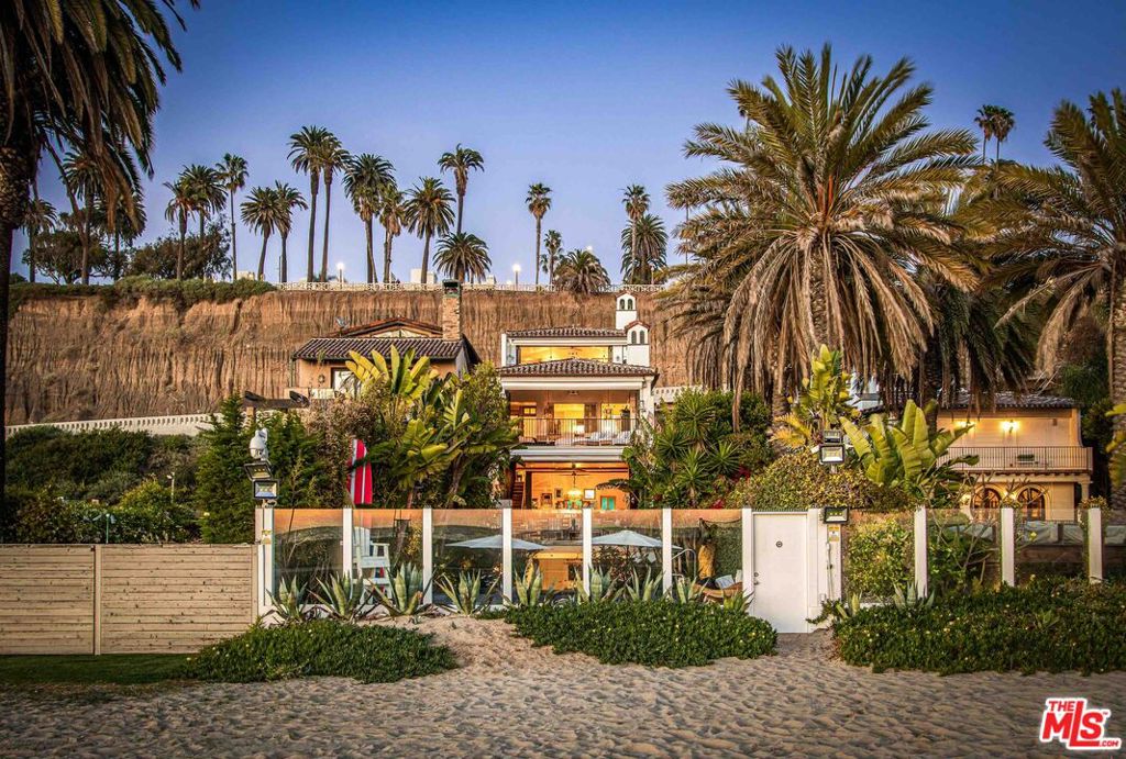This spectacular original 1920's beach house on Santa Monica's coveted Gold Coast was stunningly reimagined in 2014 by internationally-renowned Molori Design, showcasing exquisite European finishes, voluminous living spaces and panoramic ocean views. This beach-front villa provides five en-suite bedrooms plus a "spa" room as an optional sixth bedroom. The elegant custom staircase escorts you to the primary suite where walls of glass invite you out to breathtaking views of the sandy beach and ocean. This elegant oasis showcases a high ceilings & fireplace, while the spa-like bath features a fantasy claw-foot tub, steam shower & over-sized wardrobe closet. A second primary suite hosts a fireplace, private outdoor jacuzzi also with expansive ocean vistas. Each guest bedroom is en-suite with steam showers. This entertainers dream is adorned with 100 year old reclaimed oak wood floors with multiple formal and informal dining spaces, both inside & out. Family room boasts a cinema, with adjoining game room & gym. The resort-like back yard with outdoor kitchen & BBQ leads to the infinity pool, spa, lounge area & fireplace, completing the ultimate beach lifestyle. The home is offered fully furnished & equipped with beautiful top of the line decor, appliances, finishes, 24 hour security, smart-home technology, private garage & extra guest parking. Overflowing with style and bursting with fun, live your dream in this one-of-a-kind coastal estate.