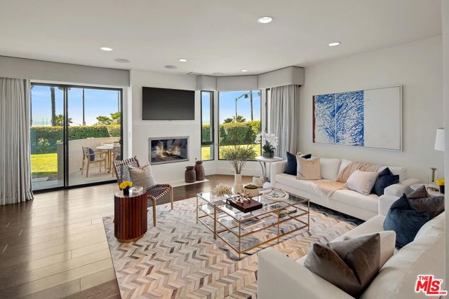 18 Sea Colony Drive Santa Monica, California Luxury oceanfront residence at the highly coveted front row at Sea Colony One. Enjoy the glistening waves of the Pacific Ocean and spectacular sunsets from this ultra-modern, sensational 3 bedroom, 3 bathroom townhome that has been remodeled with no expense spared. At the touch of a button retract the electric shades in this sophisticated home, step onto the terrace and take advantage of the remarkable, unobstructed ocean, beach and mountain views. Modern luxury at its finest at Santa Monica's premier beach. First floor chef's kitchen opens to dining and family room which leads out to patio and large grassy area. Upstairs has primary retreat with flawless bath, 2 walk-in closets and balcony as well as 2 other bedrooms and a bathroom. Other features include Control 4 system, electronic privacy glass window in primary bath and fireplaces in both living room and primary bedroom. An A+ location, just moments from all the shops and restaurants of Main street and the Promenade while still its own guard gated community.