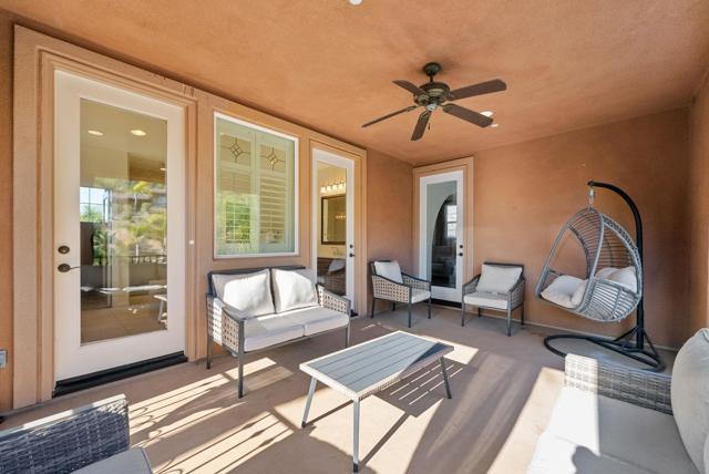 Covered patio sitting area off primary suite