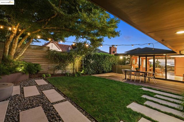 Yard at dusk featuring a fenced backyard and a patio area