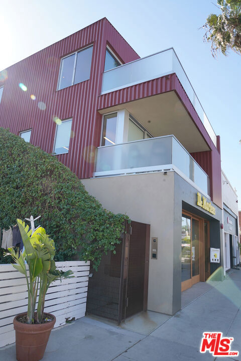 The 1134 Abbot Kinney Blvd Penthouse Residence is perfectly located right in the heart of Venice's coveted Abbot Kinney Blvd. Comprised of approximately 1900 square feet with 3 bedrooms and 2 1/2 bathrooms, this home was recently built and is perfectly perched above the street that GQ magazine named "The Coolest Block in America". The home was constructed with unrivaled attention to detail. There is an abundance of light throughout this architectural gem with clear story windows in every room. 1134 is located smack in center of the hustle bustle while providing a sense of secure, tranquil serenity once you enter the home and close the doors behind you.  Beyond your beautifully appointed gated entrance you will find some of the finest dining in Los Angeles, from Plant Food + Wine to Felix Trattoria and The Tasting Kitchen. World class dining from celebrated chefs and a shopping experience that offers some of today's hottest brands are only footsteps away. And all of this just a few blocks from world-famous Venice Beach to your west, Santa Monica to your north and Marina del Rey to your south.  Once entering the open plan great room you will enjoy an abundance of light shining through perfectly placed windows that allow the space to transform through the day making sunlight the main source of light during daylight hours. The living room features glass sliding doors which open up to a large balcony style patio, complete with fire pit, overlooking Abbot Kinney Blvd. From this vantage point you can catch the beauty of the Santa Monica sunsets while relaxing with an evening glass of Chablis. The Baulthaup kitchen features quartzite counter tops, a beautifully appointed center island and the finest Gaggenau and Miele appliances.  The architectural high ceilings boast beautiful custom wood clad paneling and a mixture of recessed and art feature focused lighting. No expense was spared in the creation of this state-of-the-art architectural home. Many windows are motorized and equipped with remote controlled shades. The entry is secured by German manufactured Seidel video entry system. There is a separate laundry area with Miele Touchtronic washer dryer and a laundry sink.  Each main room comes with a recessed flat screen television. Two of the bedrooms have large walk-in closets and the bathrooms have walk in showers with floor to ceiling glass. The master bathroom, in addition to the walk-in shower, has a large freestanding soaking tub.The Sonos sound system plays through out-of-sight in-wall speakers. A Lutron Radio RA II Automation System controls the home's lighting and motorized shades & windows. There is a 6-camera surveillance system and an environmentally conscious array of roof solar panels that reduce the electricity cost substantially. The home comes with a two-car garage, accessed from the back, secured by a 10ft tall motorized roll-up security door and a garage door. In addition to the garage parking spaces there is room for a third car in the uncovered parking area which is still within the secure space.