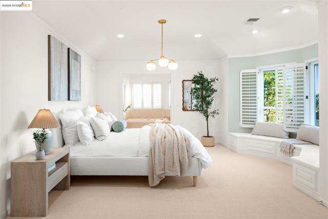 Bedroom featuring ornamental molding, multiple windows, light carpet, and recessed lighting