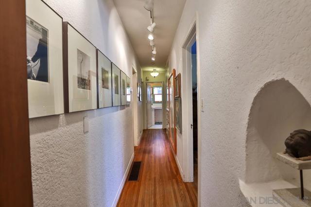 Main floor art gallery hallway with original phone nook