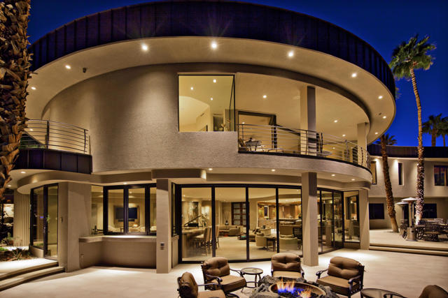 To be wholly integrated with the peaceful sanctuary that is our desert mountainside and to be entranced by awe-inspiring views of muted flights, windmills, the valley floor, and cities beyond; This is 2400 Southridge. (Must watch video: 2nd photo) A transcending experience, unlike any other, that can only be truly appreciated in person. Situated just below the Bob Hope House in the historic guard gated enclave that is Southridge, this extraordinary contemporary masterpiece, The ''Round House'', as it is known, is an architectural expression of ingenuity and the ultimate in creative design. Completely dismantled and reimagined in 2012 from below the ground up, this massive undertaking was completed to perfection as displayed the moment you open the front door. The sweeping curves of the roofline, the walls of glass showcasing our beautiful desert and surrounding desertscape seamlessly integrate the home into the hillside. The finely appointed gourmet kitchen with butler's pantry opens to the dining area, expansive sunken living room, wet bar, and billiard area, which all enjoy the views through walls of automated retractable glass panels that open to create the epitome of indoor/outdoor living. In addition, there is a 10-person theater room, fit for a Hollywood movie premiere; a private office; entry to the elevator; 2 powder rooms and pool bath with washer and dryer to complete the first-floor amenities. ... Click 'More' to Continue....