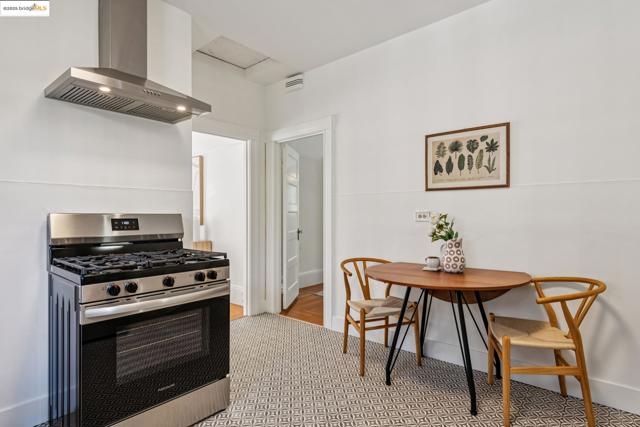 Kitchen featuring stainless steel gas stove and extractor fan
