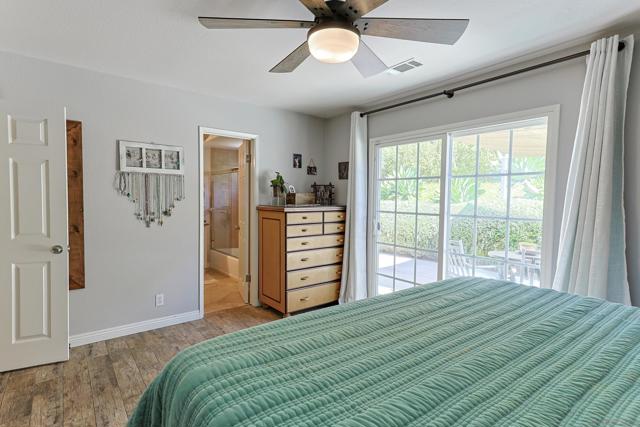 spacious primary bedroom with sliding door to the backyard.