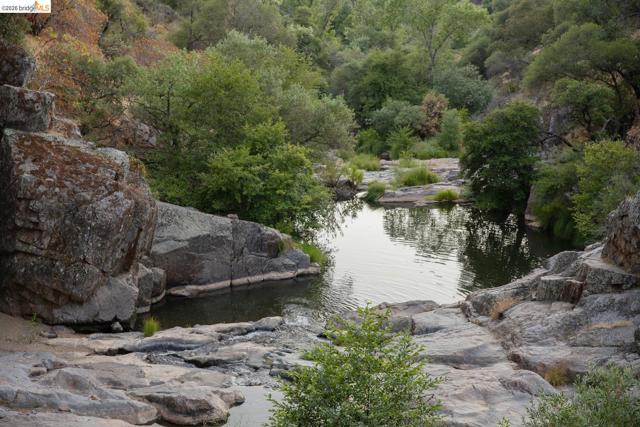 Natural rock formations surrounding a tranquil body of water
