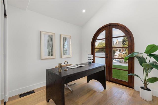 Large bedroom with custom wood french doors allowing ample natural light thoughtfully positioned in the house.